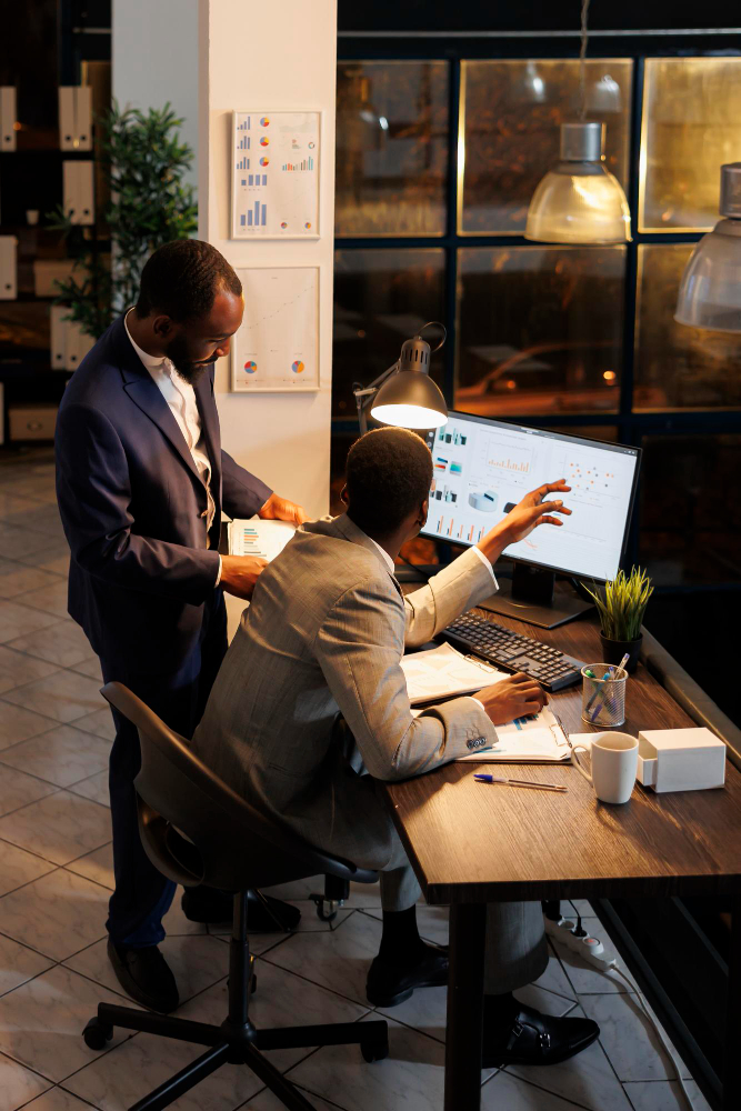 An early-career professional being mentored at a workstation